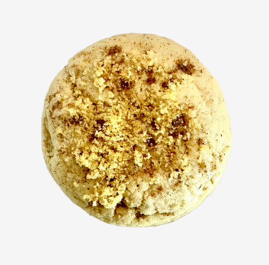 Round cookie topped with brown sugar and spices on a white background
