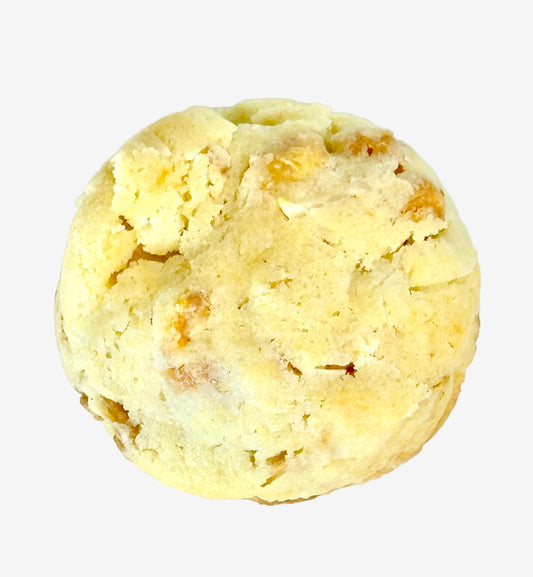 Round cookie with visible dry fruit on a white background
