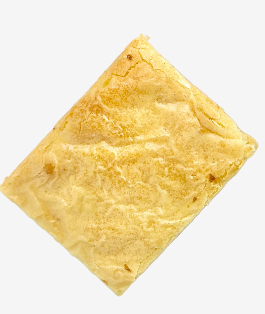 Rectangular white chocolate brownie on a white background