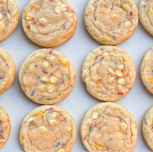 Cookies on a cooling rack with colorful sprinkles and white chocolate chips